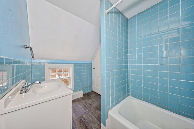 224 1st Ave, West Haven, CT 06516 - full bathroom with wood finished floors, tile walls, vanity, and washtub / shower combination
