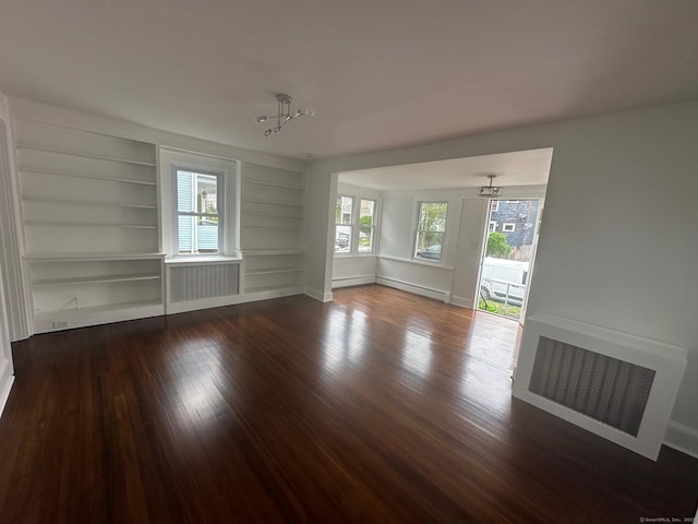14 Sherman St, Stamford, CT 06902 - empty room featuring visible vents, dark wood finished floors, built in shelves, baseboards, and radiator