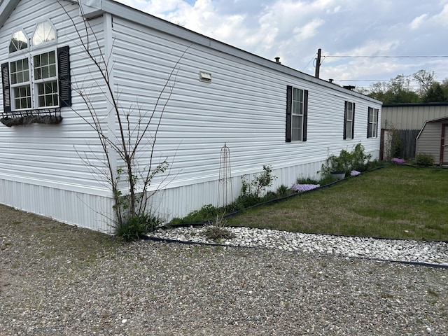 view of side of property with a yard