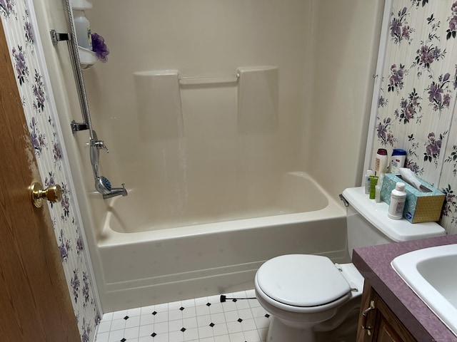 bathroom with vanity, shower / bathtub combination, and toilet