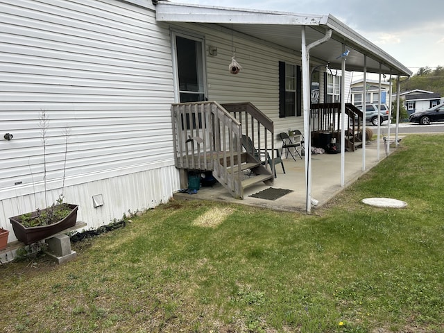 property entrance with a lawn