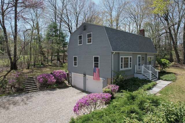 7 Partridge Ln, Burlington, CT 06013 - view of front of property with driveway, a shingled roof, a chimney, a garage, and a gambrel roof