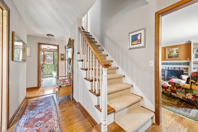 7 Partridge Ln, Burlington, CT 06013 - entryway featuring light wood-type flooring, stairway, a brick fireplace, and baseboards
