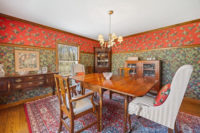 7 Partridge Ln, Burlington, CT 06013 - dining space featuring wallpapered walls, a chandelier, wood finished floors, and crown molding