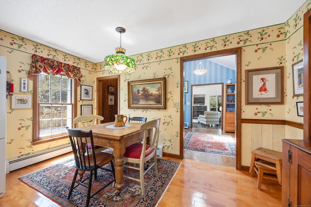 7 Partridge Ln, Burlington, CT 06013 - dining space featuring wallpapered walls, baseboard heating, and light wood-type flooring