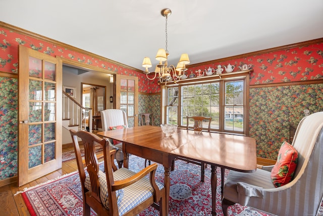 7 Partridge Ln, Burlington, CT 06013 - dining area with wallpapered walls, hardwood / wood-style floors, a chandelier, healthy amount of natural light, and baseboards