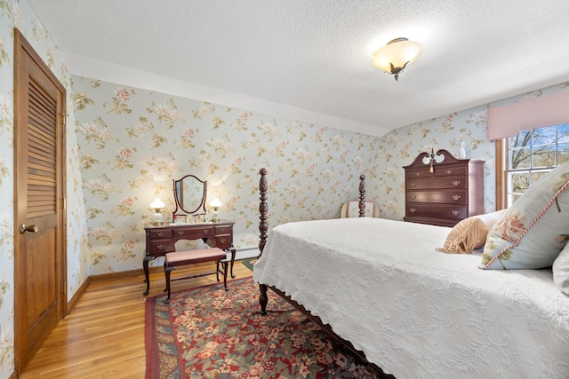 7 Partridge Ln, Burlington, CT 06013 - bedroom with light wood-type flooring, a textured ceiling, baseboards, and baseboard heating
