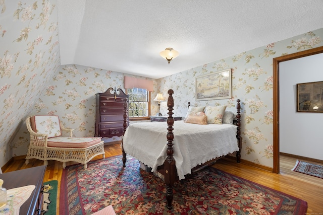 7 Partridge Ln, Burlington, CT 06013 - bedroom with wallpapered walls, wood finished floors, baseboards, and a textured ceiling