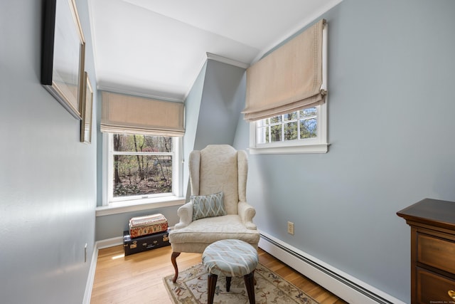 7 Partridge Ln, Burlington, CT 06013 - living area featuring baseboard heating, light wood-style floors, crown molding, and baseboards