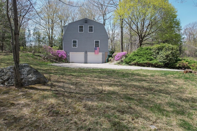 7 Partridge Ln, Burlington, CT 06013 - view of side of property featuring an attached garage, driveway, a yard, and a gambrel roof