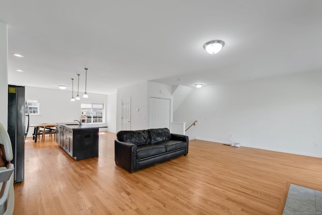 living room featuring light wood finished floors and baseboards
