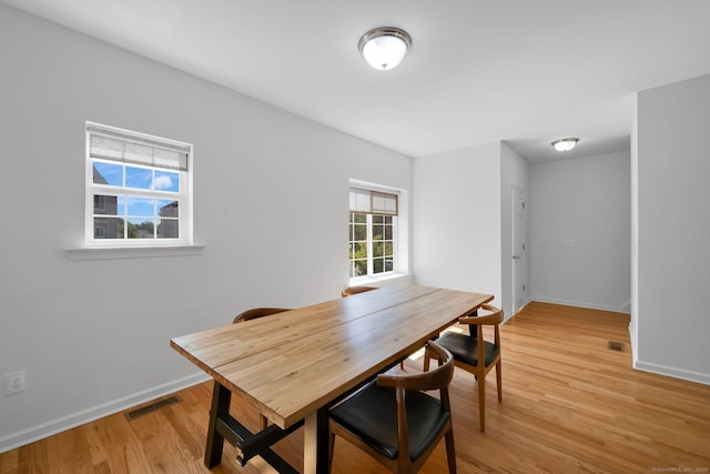 dining room featuring baseboards and light wood-style flooring