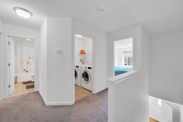 washroom with independent washer and dryer, carpet flooring, and baseboards