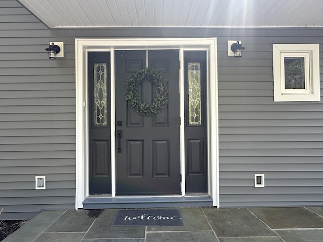 property entrance featuring uncovered parking