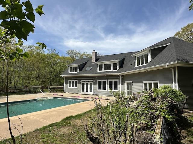 view of pool with fence, a fenced in pool, french doors, and a patio area