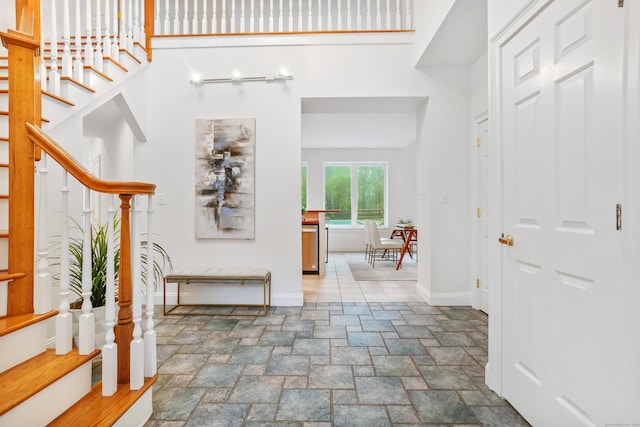 28 Drewbarrie Ln, Easton, CT 06612 - interior space featuring stairway, baseboards, a towering ceiling, and stone tile flooring