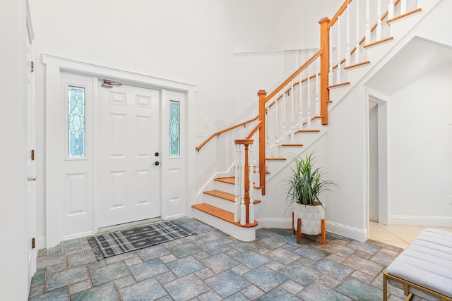 28 Drewbarrie Ln, Easton, CT 06612 - entrance foyer with baseboards, stone finish flooring, a high ceiling, and stairs