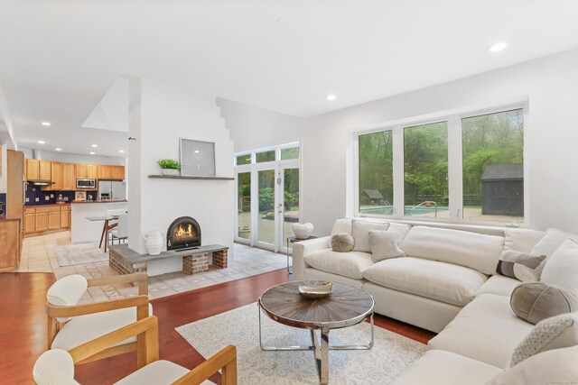 28 Drewbarrie Ln, Easton, CT 06612 - living area with light wood-style floors, recessed lighting, french doors, and a fireplace