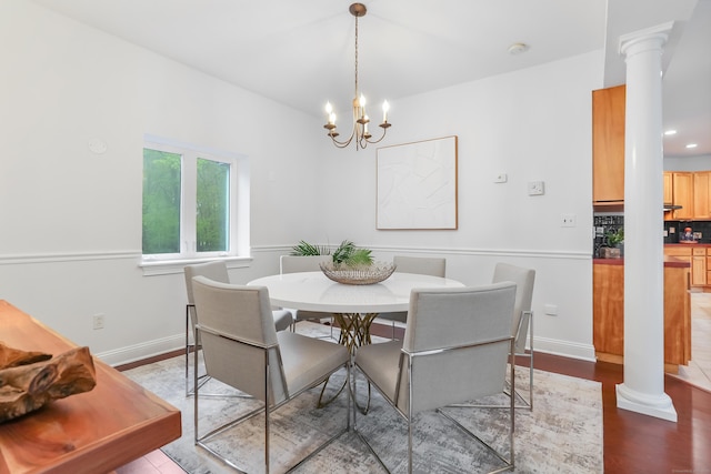 28 Drewbarrie Ln, Easton, CT 06612 - dining area featuring a notable chandelier, ornate columns, baseboards, and wood finished floors