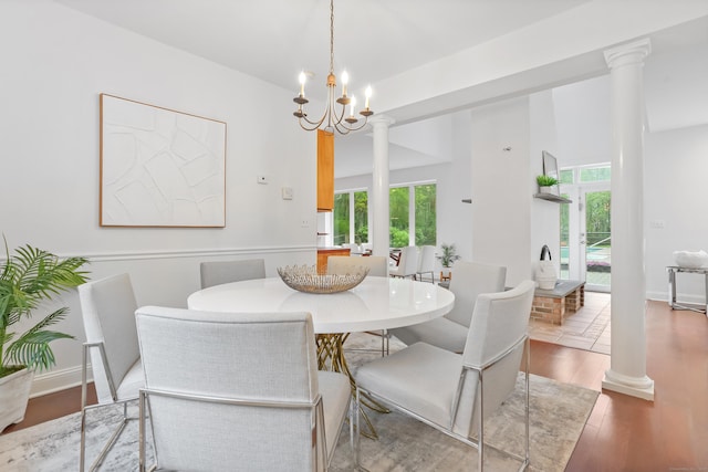 28 Drewbarrie Ln, Easton, CT 06612 - dining room with plenty of natural light, wood finished floors, ornate columns, and a notable chandelier