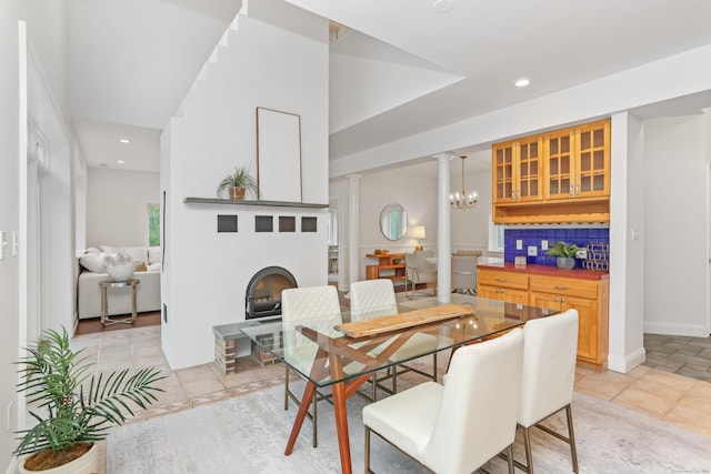 28 Drewbarrie Ln, Easton, CT 06612 - dining area with a fireplace, ornate columns, and recessed lighting