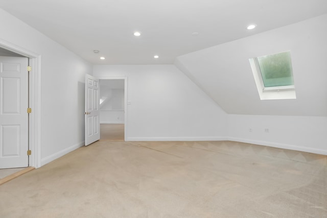 28 Drewbarrie Ln, Easton, CT 06612 - additional living space featuring light colored carpet, baseboards, vaulted ceiling with skylight, and recessed lighting