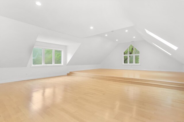 28 Drewbarrie Ln, Easton, CT 06612 - additional living space with vaulted ceiling with skylight, recessed lighting, a healthy amount of sunlight, and light wood-style floors