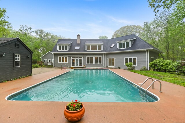 28 Drewbarrie Ln, Easton, CT 06612 - rear view of house with a patio, roof with shingles, a chimney, and an outdoor pool