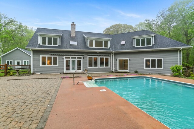 28 Drewbarrie Ln, Easton, CT 06612 - rear view of house with a patio area, a shingled roof, french doors, and an outdoor pool