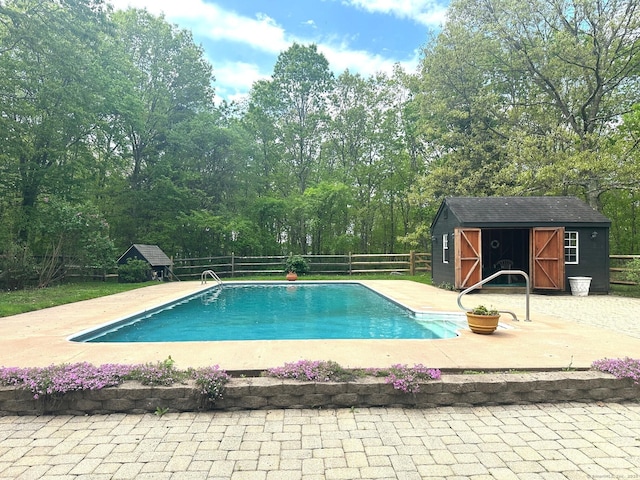 28 Drewbarrie Ln, Easton, CT 06612 - view of swimming pool featuring a storage unit, an outdoor structure, a fenced backyard, and a patio area