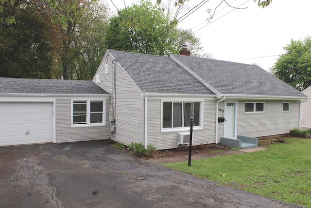 340 Robbins Ave, Newington, CT 06111 - view of front facade with roof with shingles, an attached garage, a front yard, a chimney, and driveway
