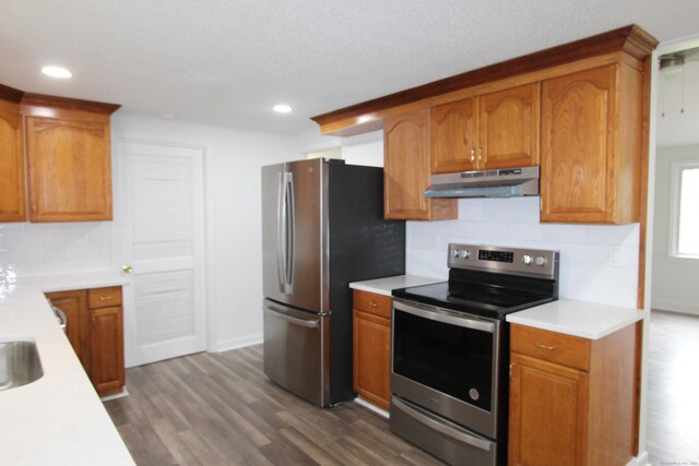 340 Robbins Ave, Newington, CT 06111 - kitchen featuring light countertops, dark wood finished floors, stainless steel appliances, tasteful backsplash, and under cabinet range hood