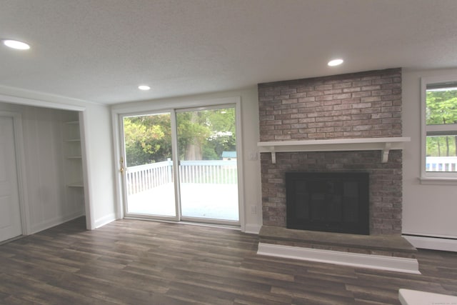 340 Robbins Ave, Newington, CT 06111 - unfurnished living room featuring wood finished floors, baseboards, a brick fireplace, and a baseboard heating unit