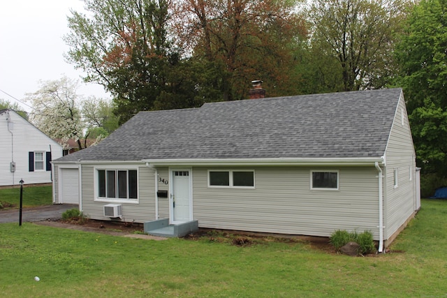 340 Robbins Ave, Newington, CT 06111 - view of front facade with a shingled roof, a front lawn, aphalt driveway, a garage, and a chimney