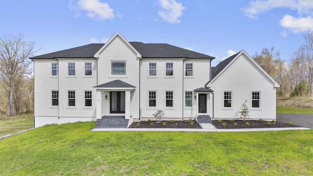 view of front of house with stucco siding and a front yard