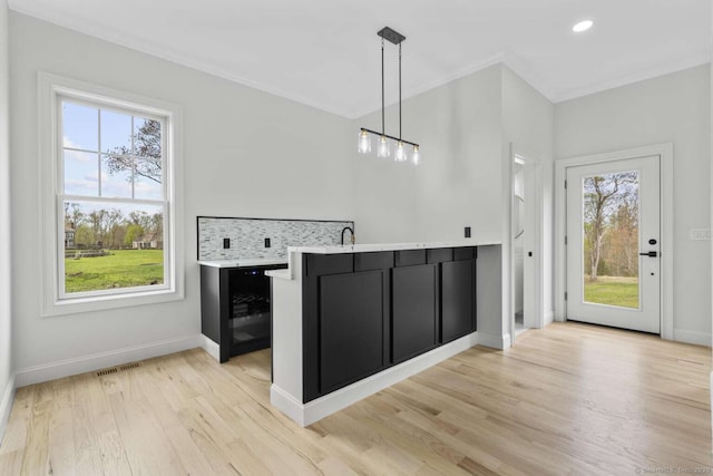 interior space featuring dark cabinets, a healthy amount of sunlight, and visible vents
