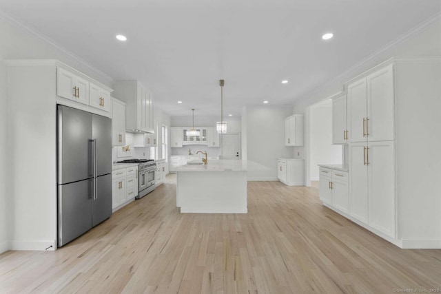 kitchen featuring light countertops, high end appliances, light wood finished floors, and white cabinetry