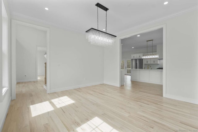 unfurnished dining area featuring recessed lighting, a chandelier, ornamental molding, and light wood-style floors