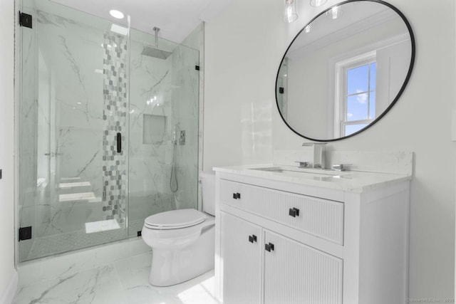 bathroom featuring toilet, a marble finish shower, marble finish floor, and vanity