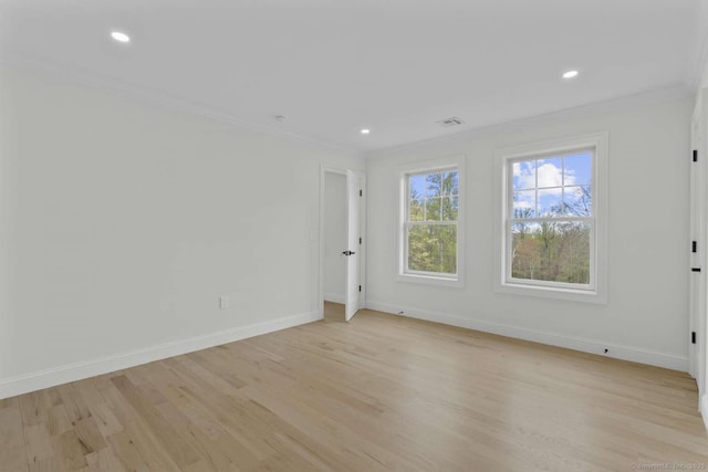 unfurnished room featuring crown molding, baseboards, and light wood-style floors