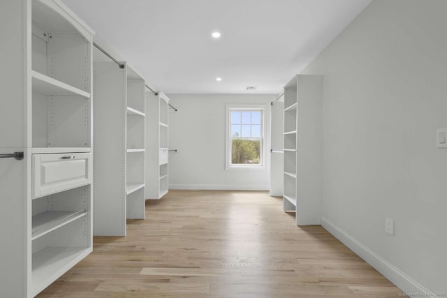 spacious closet featuring visible vents and light wood-style flooring