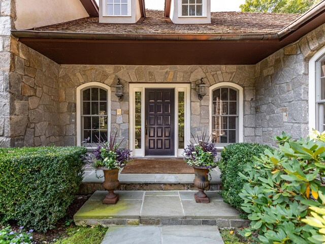 entrance to property featuring stone siding