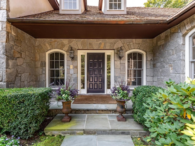 property entrance with stone siding
