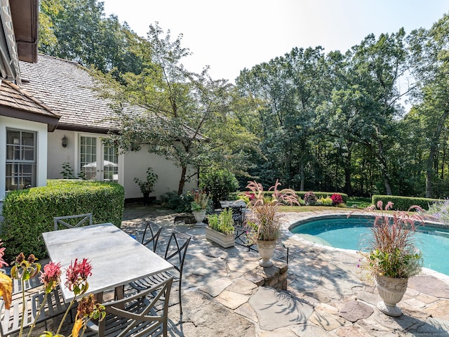 outdoor pool featuring a patio and outdoor dining area