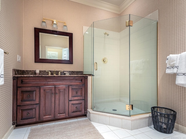 bathroom featuring crown molding, tile patterned flooring, a stall shower, vanity, and baseboards