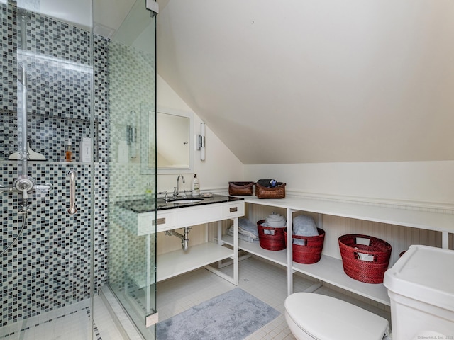 bathroom featuring toilet, a stall shower, vaulted ceiling, vanity, and tile patterned floors
