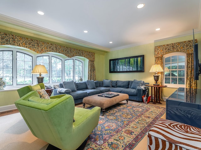 living area with crown molding, plenty of natural light, recessed lighting, and baseboards