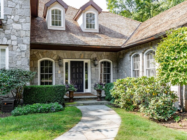 view of exterior entry featuring stone siding