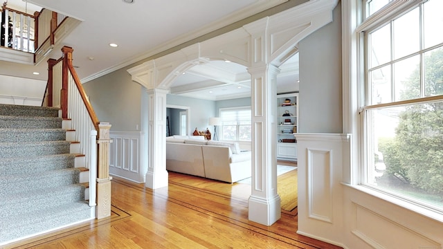 27 Dock Rd, Milford, CT 06460 - staircase featuring ornamental molding, decorative columns, wood finished floors, and a healthy amount of sunlight
