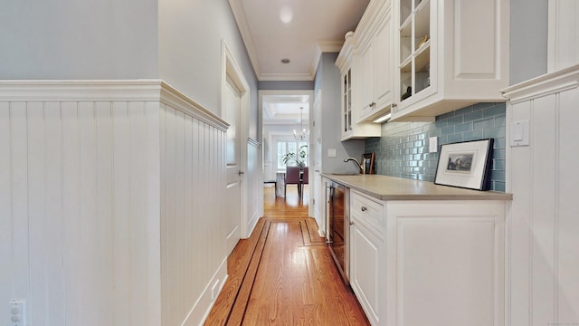 27 Dock Rd, Milford, CT 06460 - corridor featuring beverage cooler, ornamental molding, and wood finished floors